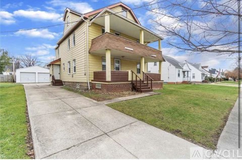 A yellow house with a white garage door is in front of a white house.
