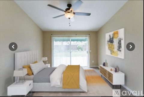A bedroom with a bed, nightstand, and a ceiling fan.