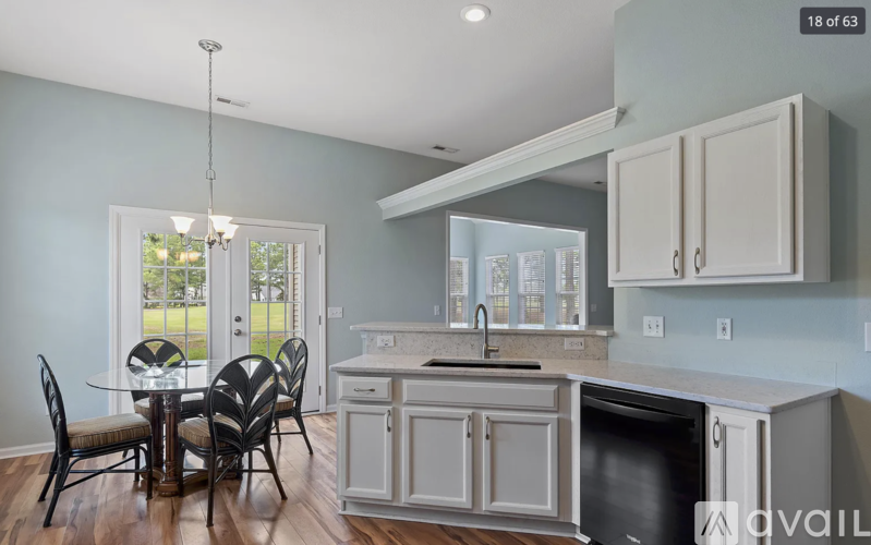 A kitchen with a table and chairs and a window.