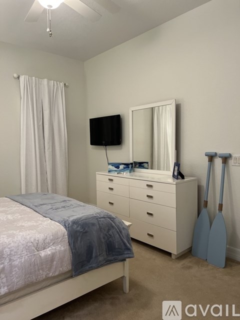 A bedroom with a bed, dresser, and mirror.