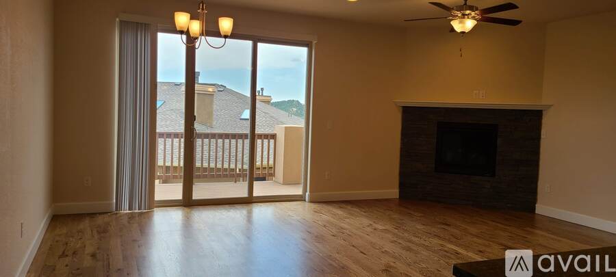 A living room with a fireplace and sliding glass doors.