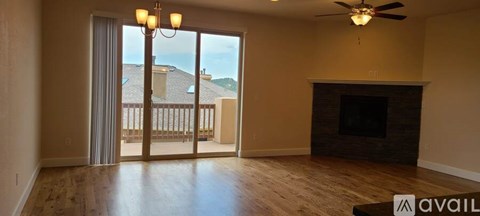 A living room with a fireplace and sliding glass doors.