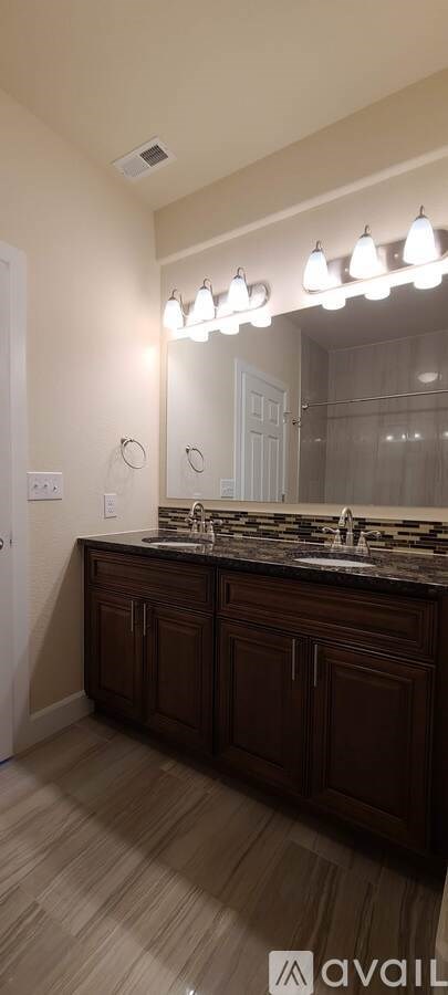 A bathroom with a vanity and a mirror.