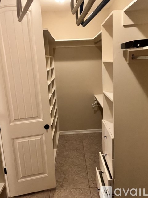 A white door is open to a hallway with a mirror on the wall.