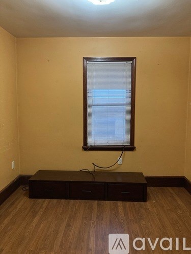A room with a window and a bench.