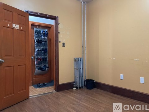 A room with a brown door and a white radiator.