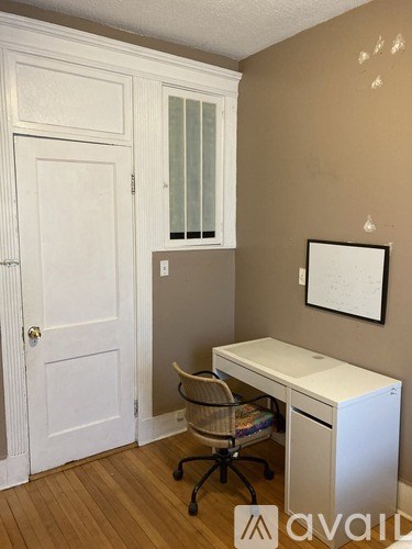 A room with a desk and a chair.