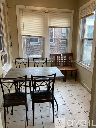 A dining room with a table and chairs.