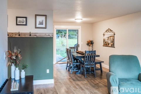 A living room with a dining table and chairs.