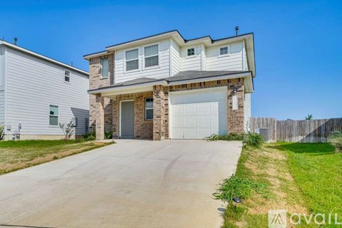 A two-story house with a garage is for sale.