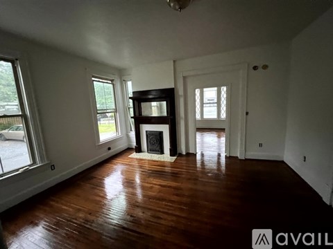 A room with wooden floors and a fireplace.