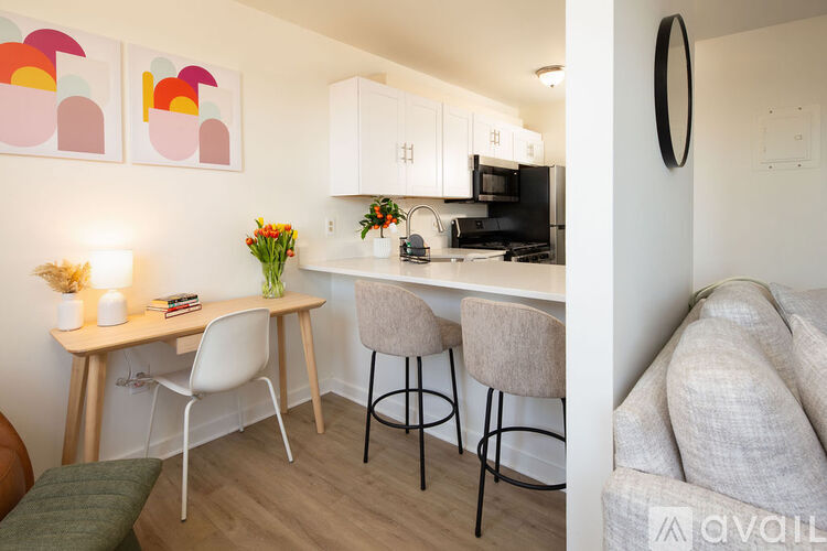 A kitchen with a table and chairs and a couch.
