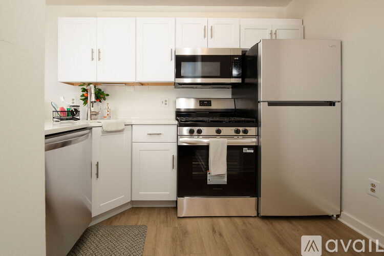 A kitchen with white cabinets and stainless steel appliances.