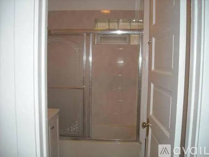 A small bathroom with a walk-in shower and a toilet.