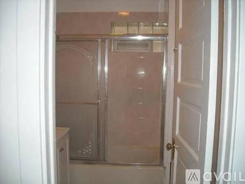 A small bathroom with a walk-in shower and a toilet.
