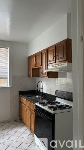 A kitchen with black countertops and wooden cabinets.