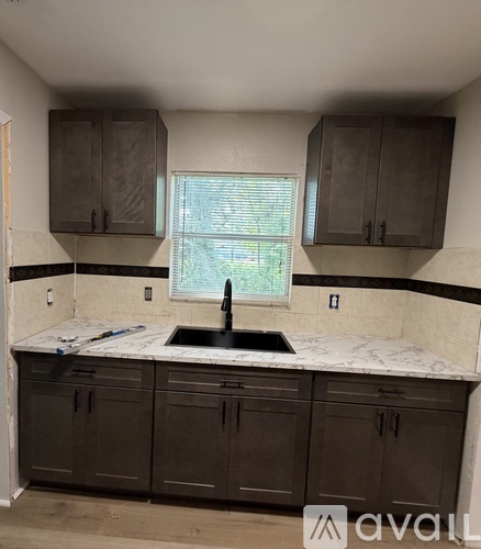 A kitchen with a sink and cabinets.