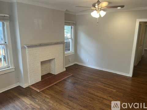 A room with a fireplace and wooden floors.