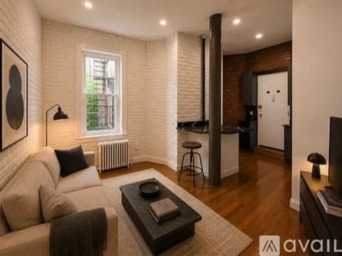 A living room with a white couch and a coffee table.