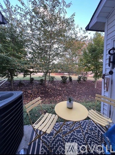 A patio with a table and chairs.