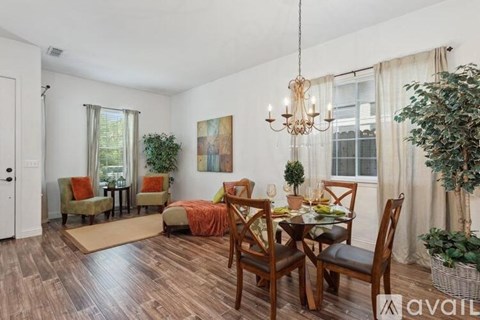A dining room with a wooden table and chairs.