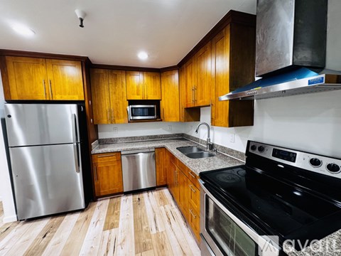 A kitchen with wooden cabinets and stainless steel appliances.