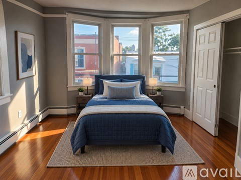 A bedroom with a large bed and a view of the city.