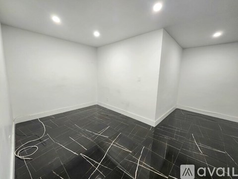 A room with a black floor and white walls.