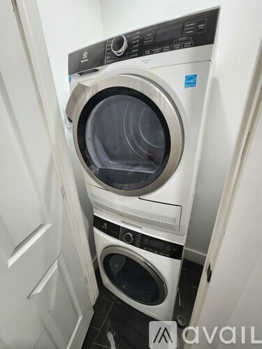 A stacked washer and dryer in a small space.