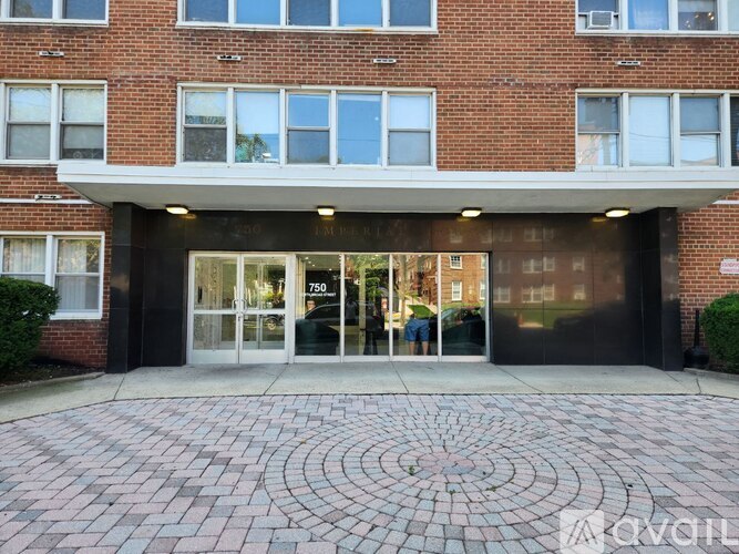 A brick building with a glass entrance and the number 750 on it.