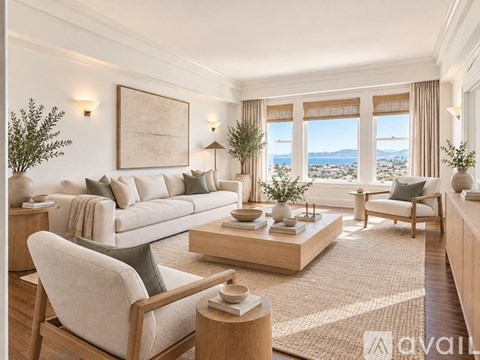 A living room with a large window overlooking a landscape.
