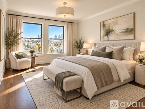 A well-lit bedroom with a large bed and a view of the city.