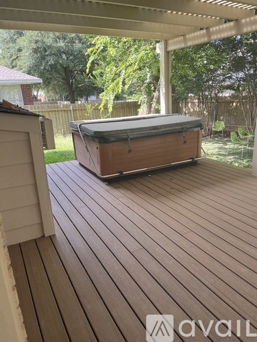 A hot tub sits on a wooden deck.