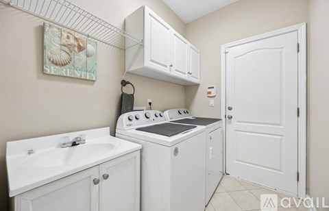 A small kitchen with a white oven and cabinets.