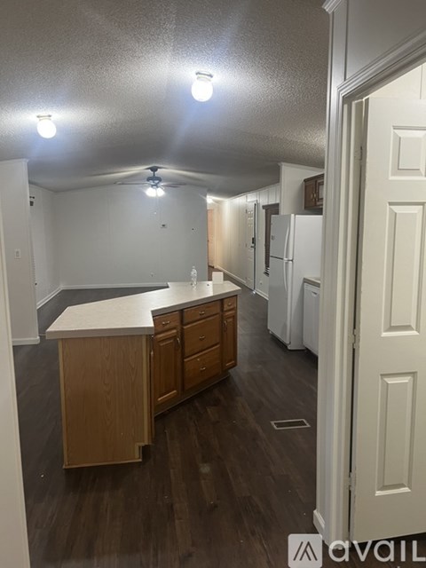A kitchen with wooden cabinets and a white countertop.