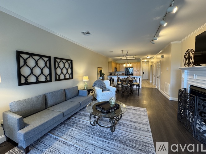 A living room with a grey sofa and a fireplace.