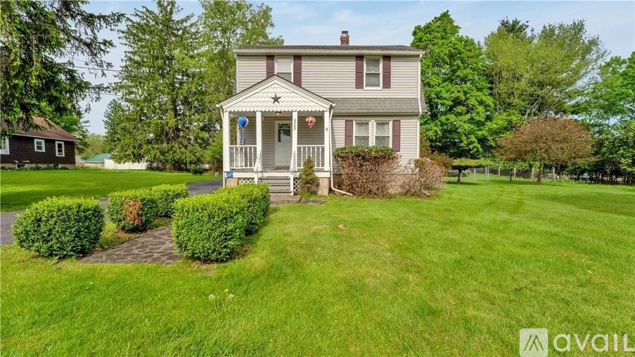 A house with a porch and a small garden in front.