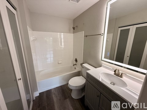 A bathroom with a toilet, sink, and bathtub.