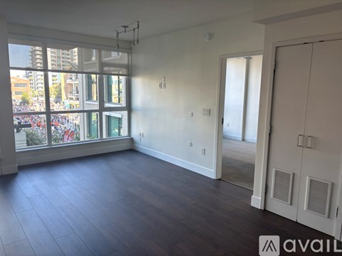 A room with a large window overlooking a busy street.