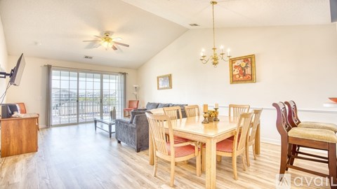 A dining room with a wooden table and chairs.