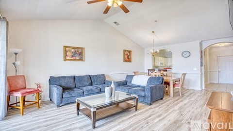 A living room with a blue couch and a coffee table.