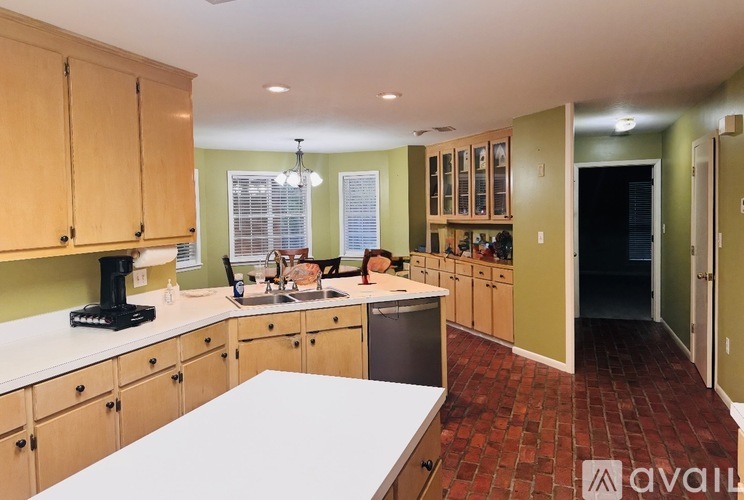 A kitchen with wooden cabinets and a white countertop.