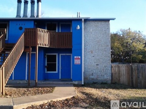 A blue house with a sign on the door.
