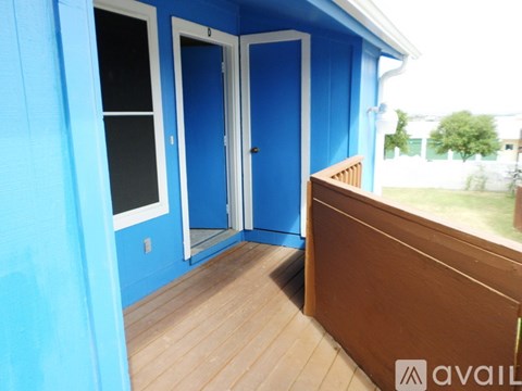 A blue house with a white door and a window.