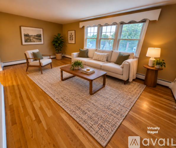 A living room with a couch, chair, and coffee table.