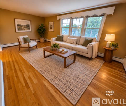 A living room with a couch, chair, and coffee table.