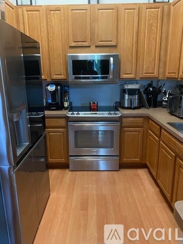 A kitchen with wooden cabinets and stainless steel appliances.