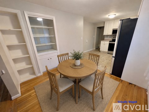 A dining room with a round table and chairs.