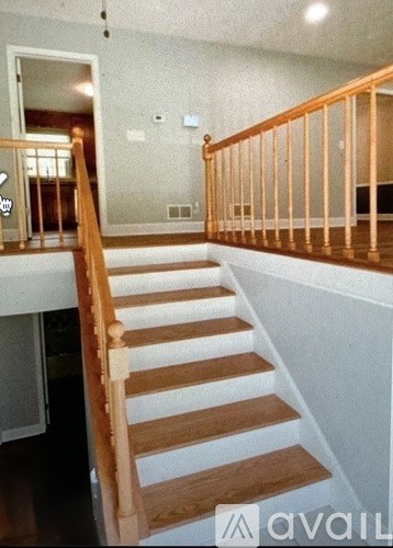 A wooden staircase with white risers.