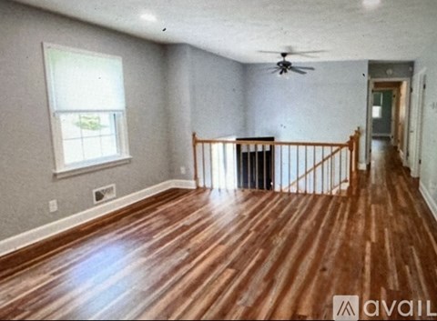A room with wooden floors and a window.